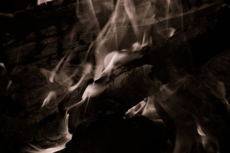 Burning wood logs, cooking on fire, warm evening, sparkles in the air, warm air from the fire....