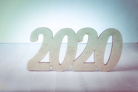 New year composition with wooden figures 2020. Toned.