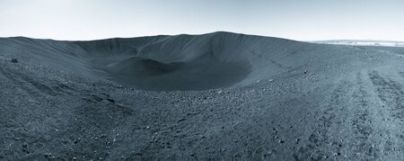 Black sand volcano mountain slope and lava remains in Iceland. Toned.