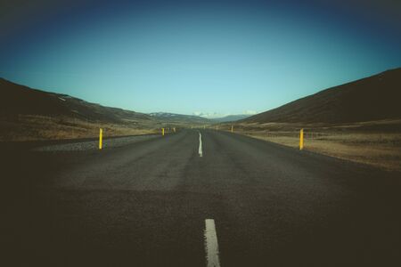 Road on a calm deserted spring landscape of Iceland. Toned.の写真素材
