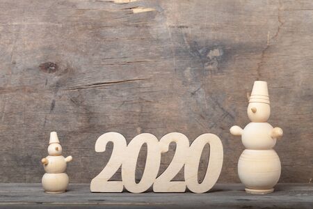 Wooden figures on the old wooden background. Happy new Year theme.の写真素材
