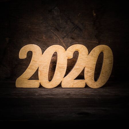 Wooden figures on the old wooden background. Happy new Year theme. Toned.の写真素材