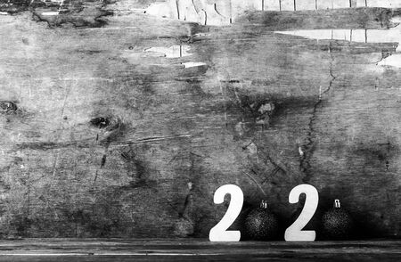 Wooden figures on the old wooden background. Happy new Year theme. Toned.