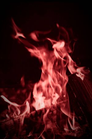 Burning wood logs, cooking on fire, warm evening, sparkles in the air, warm air from the fire....