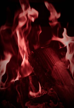 Burning wood logs, cooking on fire, warm evening, sparkles in the air, warm air from the fire....