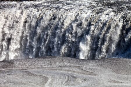 Stormy water and dirty spring snow. Beautiful view to the Dettifoss waterfall in Iceland.