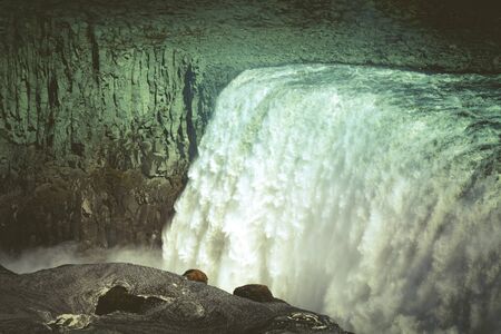 Stormy water and dirty spring snow. Beautiful view to the Dettifoss waterfall in Iceland. Toned.の写真素材
