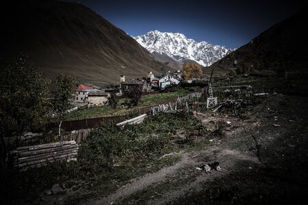 View of the village of Ushguli in a beautiful autumn landscape with white clouds in Svaneti. Georgia. Toned.の写真素材