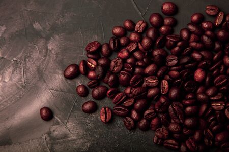 Composition with a coffee beans on a textured plastered background with a variety of arbitrary stains. Toned.の写真素材