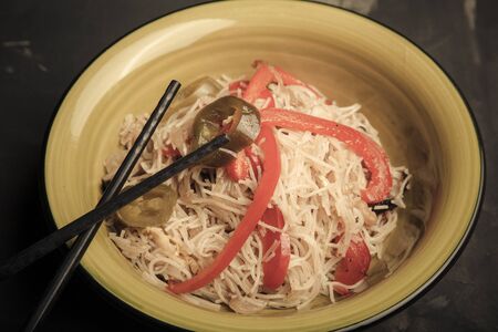 Composition with a bowl of rice noodles, meat and vegetables. Toned.の写真素材