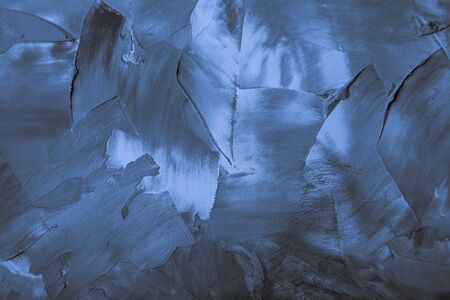 Textured plastered background with a variety of arbitrary stains. Blue. Toned.