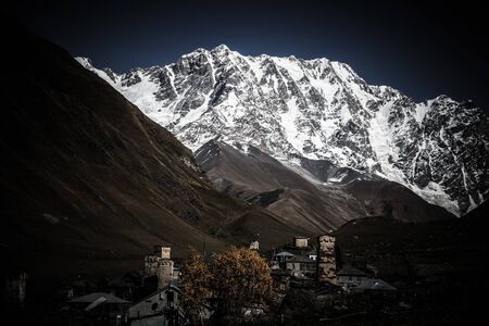 View of the village of Ushguli in a beautiful autumn landscape with white clouds in Svaneti. Georgia. Toned.の写真素材