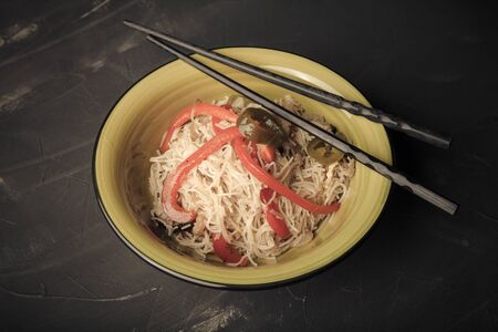 Composition with a bowl of rice noodles, meat and vegetables. Toned.の写真素材