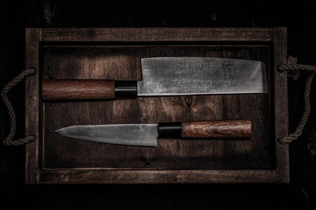Chopping knives on a dark table. Toned.