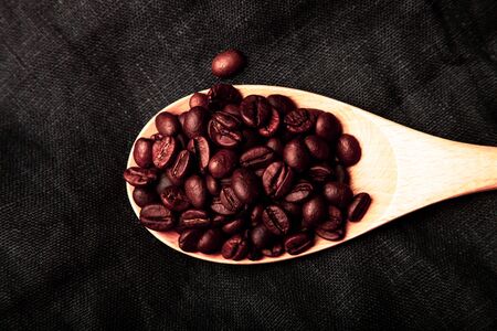 Composition with a coffee beans on a linen napkin for background. Toned.の写真素材