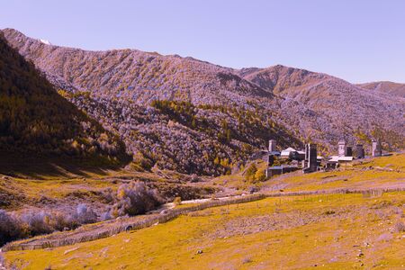 View of the village of Ushguli in a beautiful autumn landscape with white clouds in Svaneti. Georgia. Toned.の写真素材