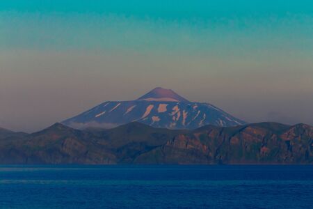 View on a Kunashir island with volcano Tyatya from the sea. Toned.の写真素材