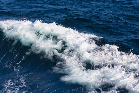 White crest of a sea wave. Selective focus. Shallow depth of field.の写真素材