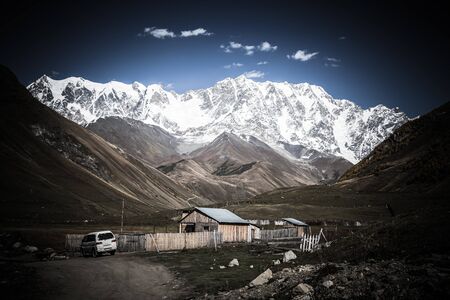 View of the village of Ushguli in a beautiful autumn landscape with white clouds in Svaneti....