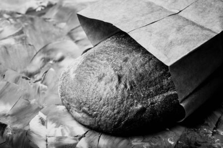 Composition with a bread on a textured plastered surface. Toned.の写真素材