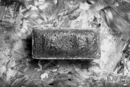 Composition with a bread on a textured plastered surface. Toned.の写真素材