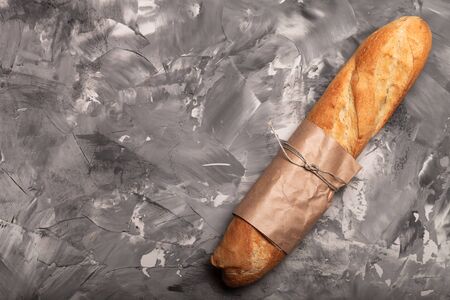 Composition with a bread on a textured plastered surface.の写真素材