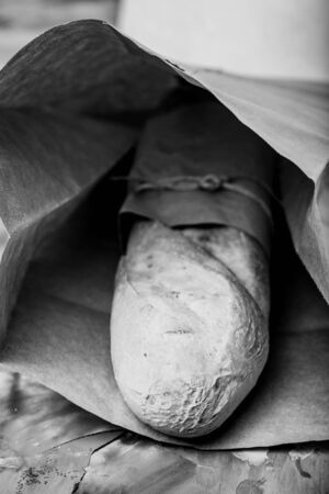 Composition with a bread on a textured plastered surface. Toned.の写真素材