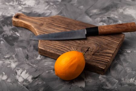 Composition with a lemon on a textured plastered surface.の写真素材