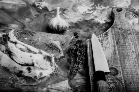 Composition with a meat prepared for cooking on a textured plastered surface. Toned.の写真素材