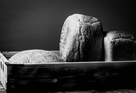 Composition with a bread on a textured plastered surface. Toned.の写真素材