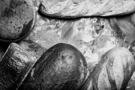Composition with a bread on a textured plastered surface. Toned.