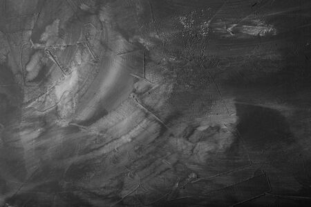 Textured plastered background with a variety of arbitrary stains. Gray.