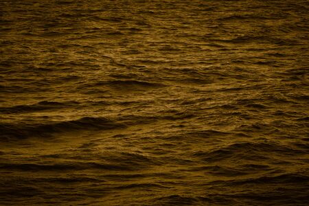 Surface of a calm blue sea. Selective focus. Shallow depth of field. Toned.