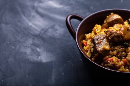 Large portion of pilaf in a clay dish.の写真素材