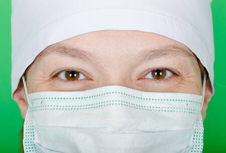 Woman doctor with laughing eyes. Protective mask on her face.の写真素材