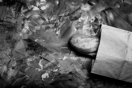 Composition with a bread on a textured plastered surface. Toned.の写真素材