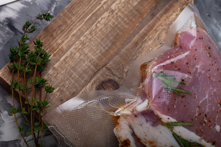 Composition with a meat prepared for cooking on a textured plastered surface.の写真素材