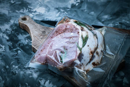 Composition with a meat prepared for cooking on a textured plastered surface. Toned.の写真素材
