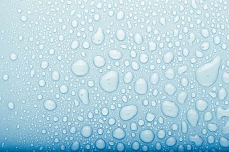 Drops of water on a color background. Selective focus. Blue. Toned.の写真素材