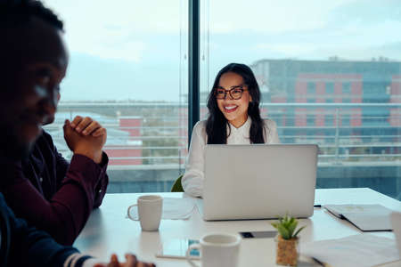 Smiling young businesswoman at a corporate business meetingの写真素材