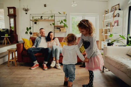 Girls holding hands and playing at home