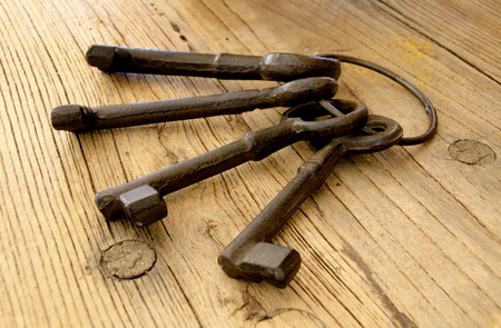 a bunch of big antique keys on wooden table