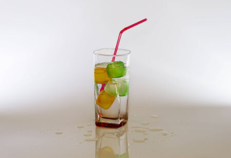 Iced cold sparkle water with colour cubesの写真素材