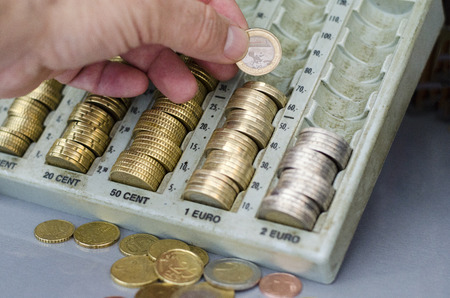 Hand with euro coins changing money