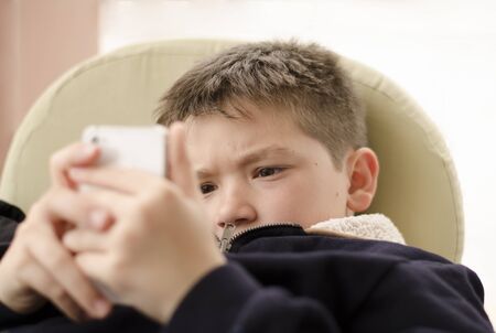 Boy kid child playing with mobile phone