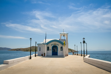 Perspective image of a Small greek orthodox chapel with some clouds aboveの写真素材