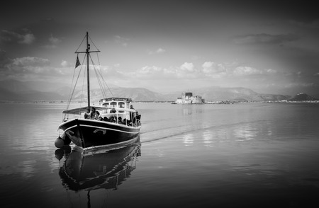 Nafplio,Bourtzi, Greece - December 27, 2015: Boats with tourists,sailing in calm waters of the...