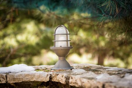 Retro classic style garden electric iron lamp over stonesの写真素材