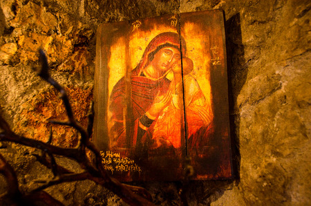 Arcadia,Greece - Octomber 26, 2014: Religious orthodox wooden icon on rocks. Found on an old very small church inside a caveのeditorial素材