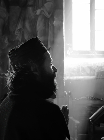 CORINTH, GREECE - OCTOBER 10: Christian Orthodox monk pray inside monastery of St. George in Corinth, Greeceのeditorial素材